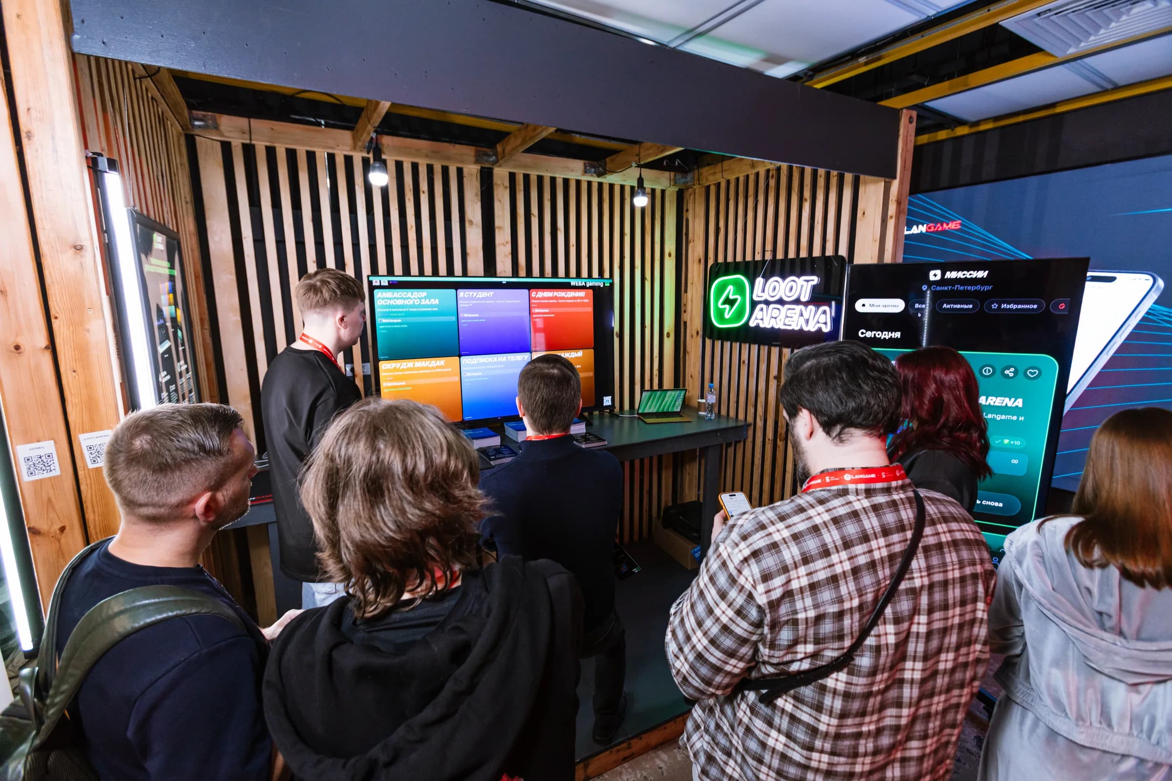 Guests watch a live ERP and player app demo at the Loot Arena booth at LANGAME 2026